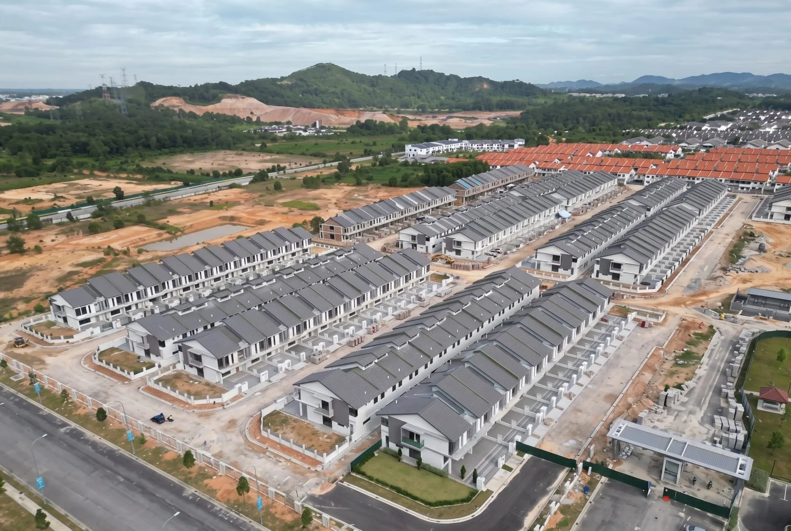 Undated aerial development imagery showing rows of homes and surrounding land
